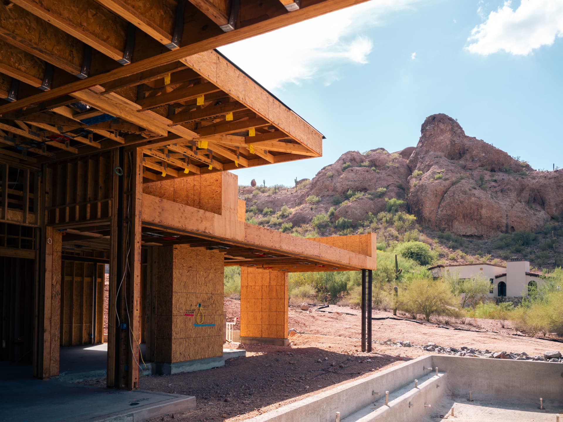 Wood framing under a red-rock hillside